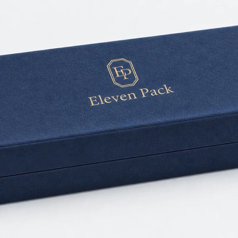 Gold ElevenPack logo finish on a navy velvet necklace box lid Gold ElevenPack logo finish on a navy velvet necklace box lid