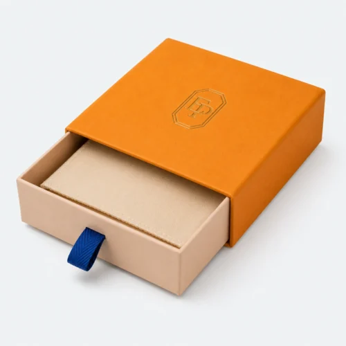 Half-open orange paper drawer gift box with beige padded insert