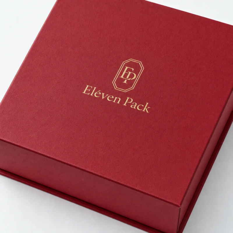 Gold foil ElevenPack logo detail on a red paper gift box lid Gold foil ElevenPack logo detail on a red paper gift box lid