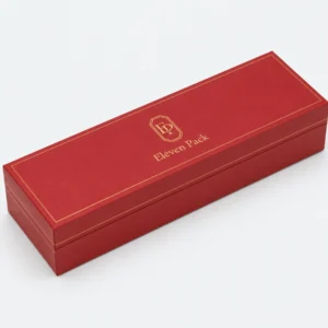 Closed long red leather bangle box with gold logo and border