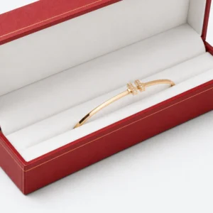 Gold bangle retention detail in a long white jewelry box insert