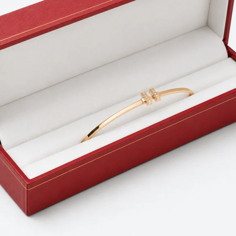 Gold bangle retention detail in a long white jewelry box insert