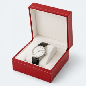 Open custom red leather hinged watch box with a fitted white pillow Open custom red leather hinged watch box with a fitted white pillow