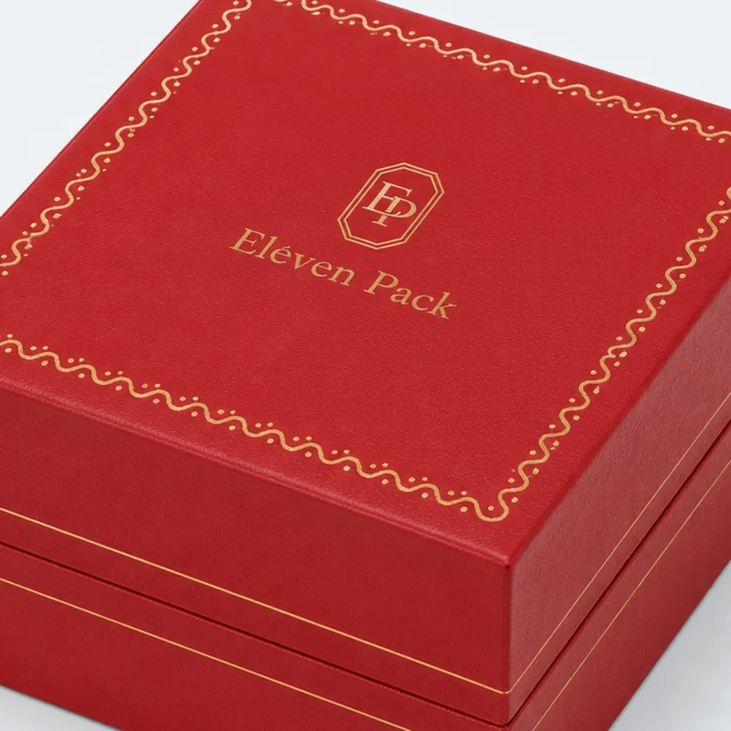 Red leather watch box lid detail with gold decorative finishing Red leather watch box lid detail with gold decorative finishing
