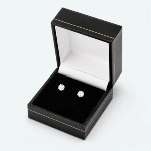 Open custom black leather hinged earring box with two stud earrings Open custom black leather hinged earring box with two stud earrings