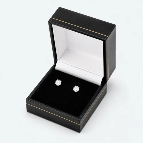 Open custom black leather hinged earring box with two stud earrings