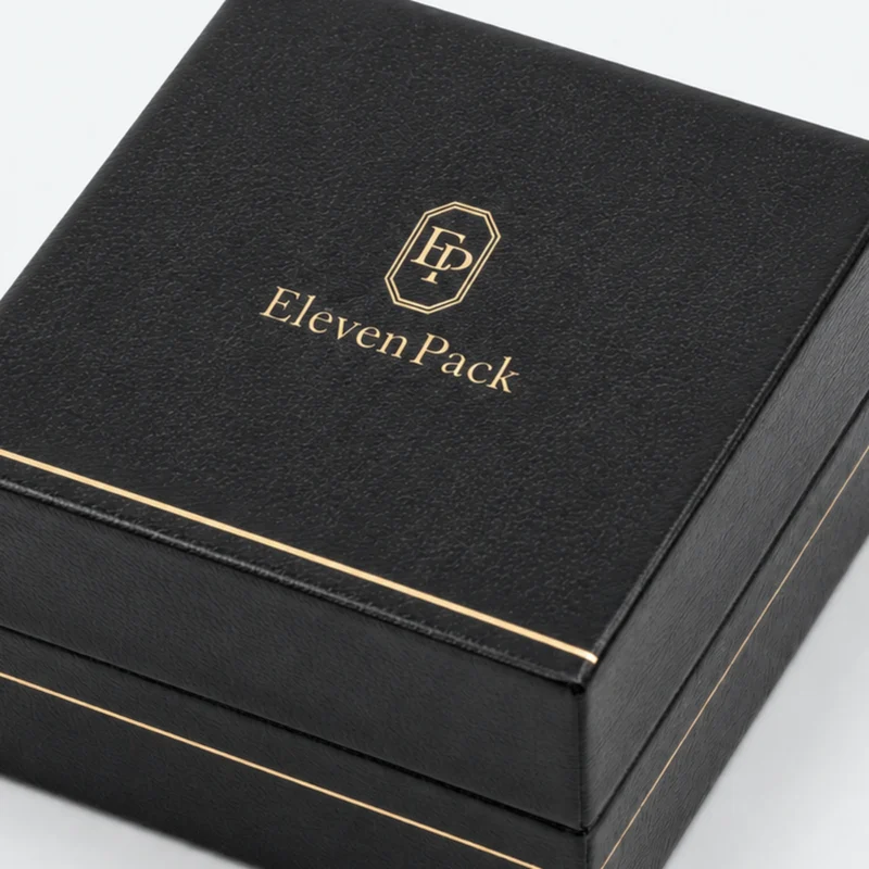 Black leather earring box detail showing fine gold edge finishing Black leather earring box detail showing fine gold edge finishing