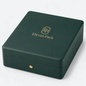 Closed green leather jewelry box with gold logo and crown-shaped closure