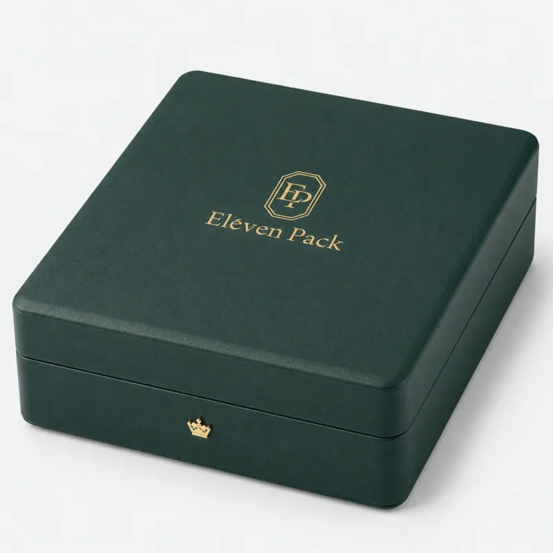 Closed green leather jewelry box with gold logo and crown-shaped closure