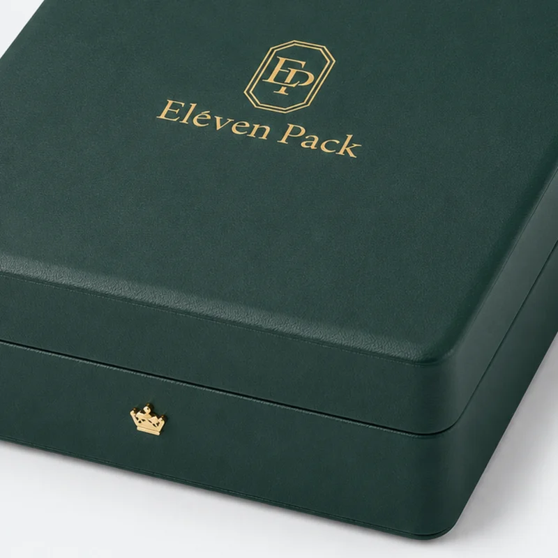 Green leather jewelry box detail with gold crown-shaped front closure
