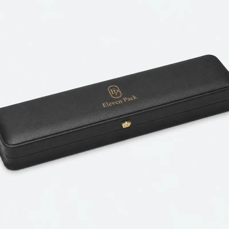 Closed black genuine leather necklace box with gold logo and button clasp Closed black genuine leather necklace box with gold logo and button clasp