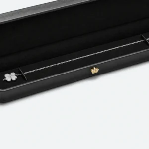 Necklace chain retention detail inside a long black presentation box Necklace chain retention detail inside a long black presentation box