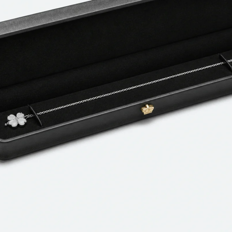 Necklace chain retention detail inside a long black presentation box Necklace chain retention detail inside a long black presentation box