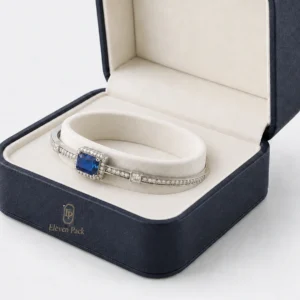 Silver and blue stone bangle seated around the ivory annular cushion