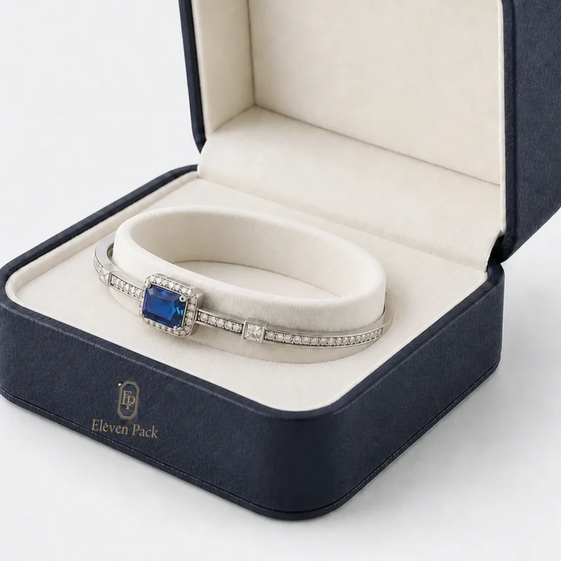 Silver and blue stone bangle seated around the ivory annular cushion