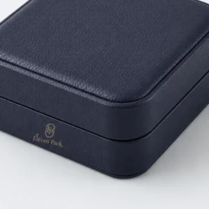 Dark blue leather bangle box detail with front logo and rounded seam