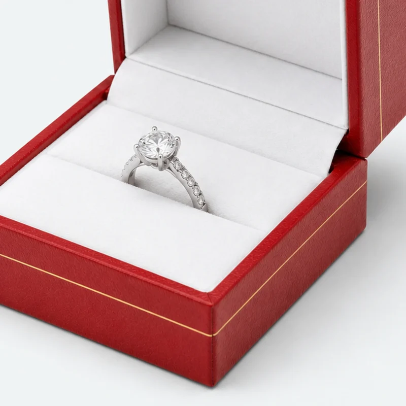 White ring-roll seating detail inside a red leather jewelry box
