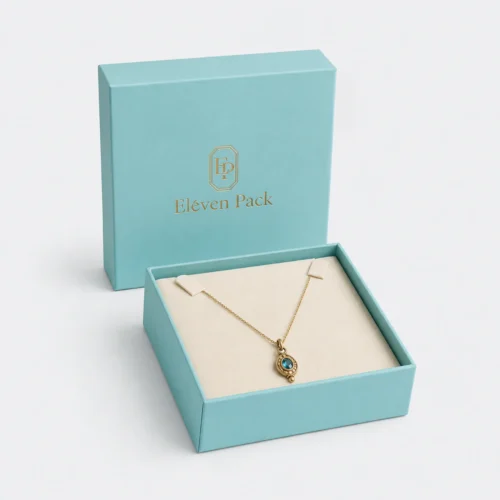 Open turquoise paper jewelry gift box with cream necklace insert