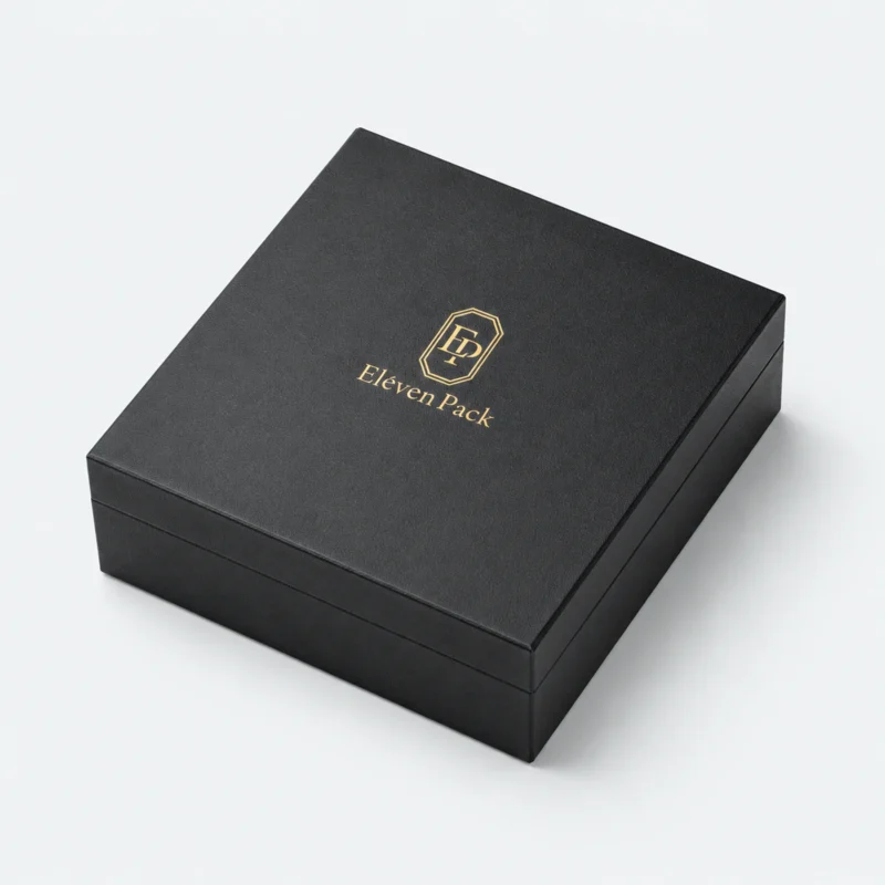 Closed black rigid paper jewelry box with gold Eleven Pack logo