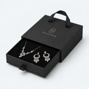 Open black cardboard drawer jewelry box with necklace and earrings