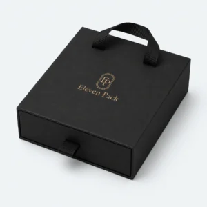 Closed black cardboard drawer jewelry box with ribbon handles and gold logo