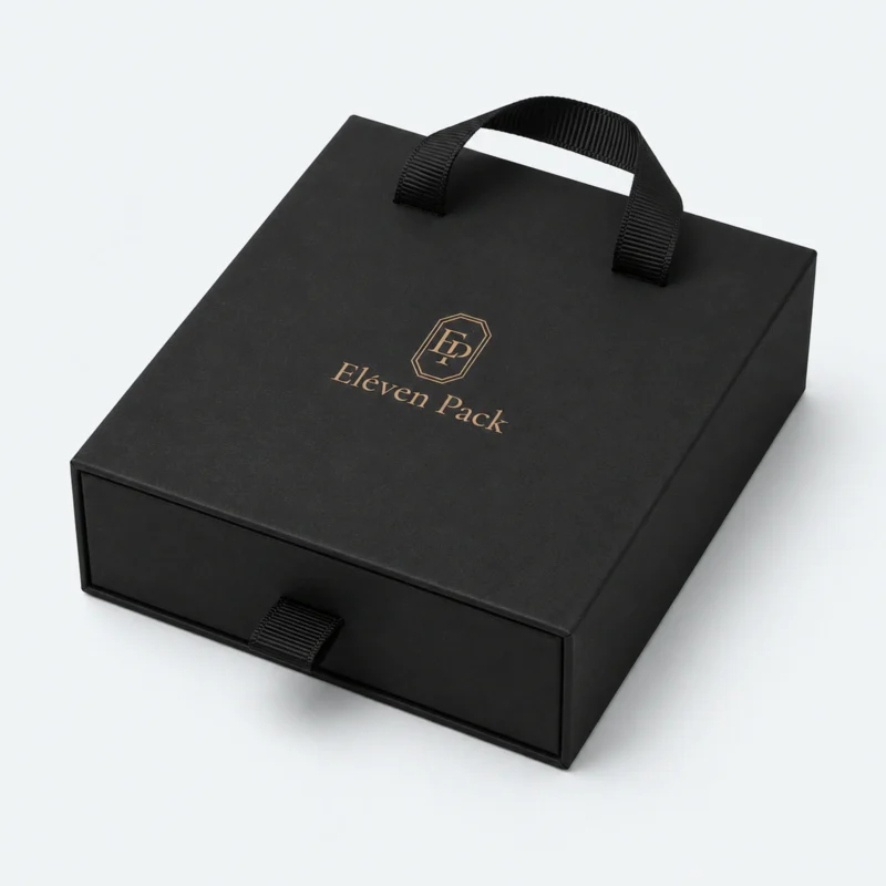 Closed black cardboard drawer jewelry box with ribbon handles and gold logo