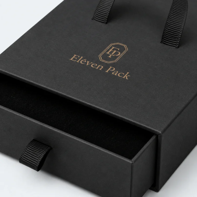 Close-up of black ribbon pull and aligned jewelry box drawer sleeve
