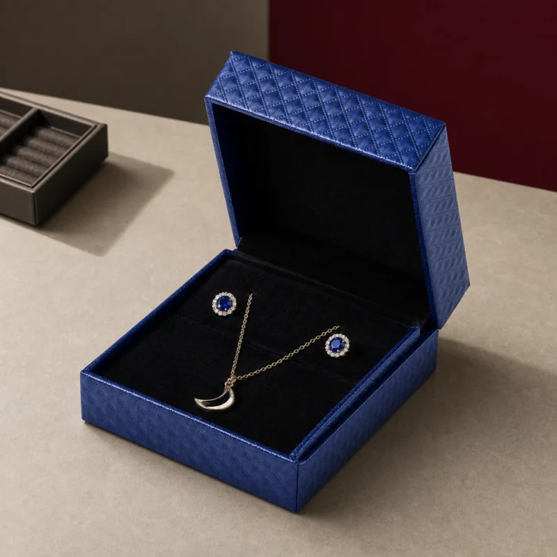 Open blue jewelry box on a burgundy-accented boutique counter