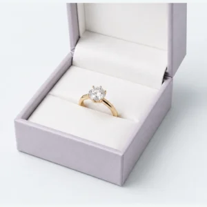 Close-up of a gold solitaire ring seated in the white insert slit