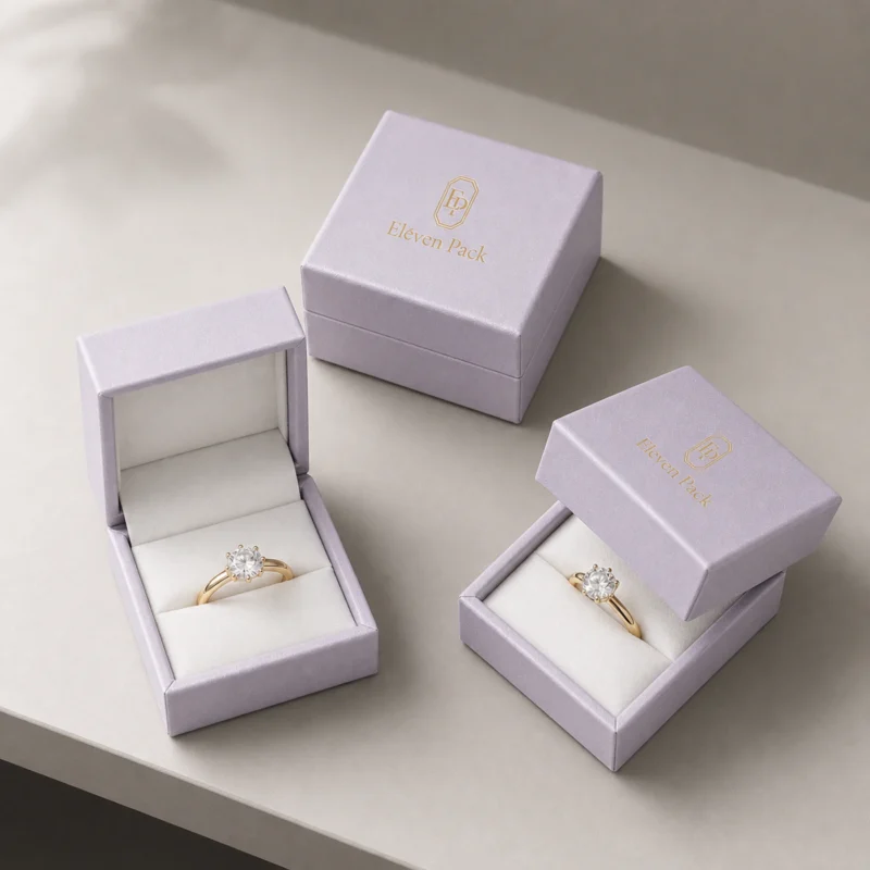 Three pale lilac hinged ring boxes in open and closed states