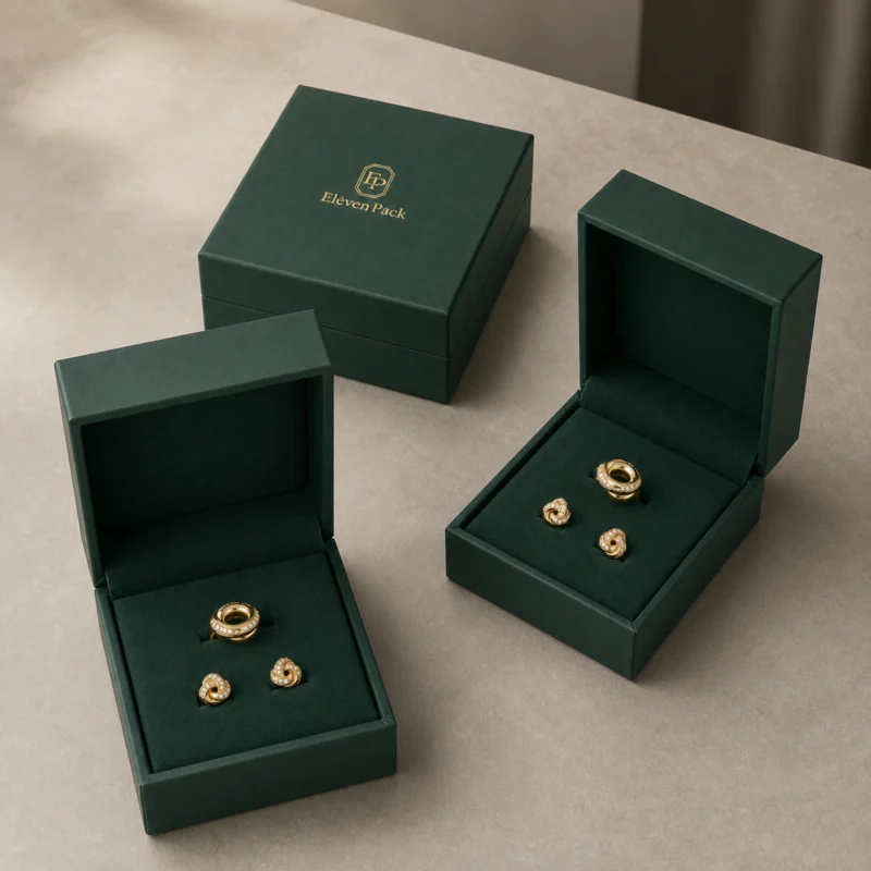 Three green hinged jewelry boxes in a showroom grouping