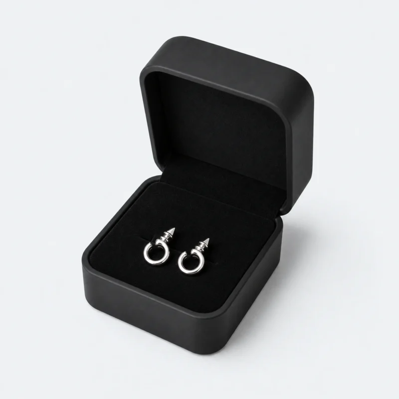 Open black rounded earring box with matching silver hoop earrings