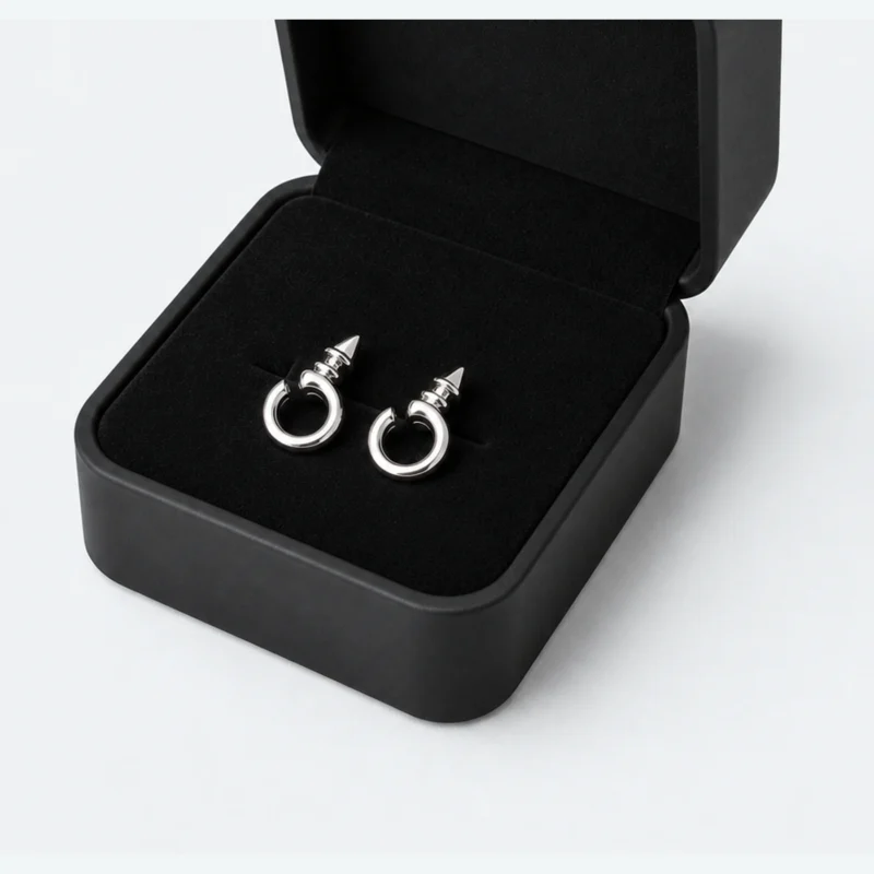 Close-up of a black insert holding a matching earring pair