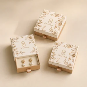 Three coordinated floral drawer earring boxes on a beige backdrop