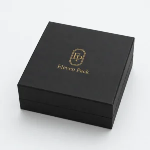 Closed black cardboard jewelry box with centered gold Eleven Pack logo
