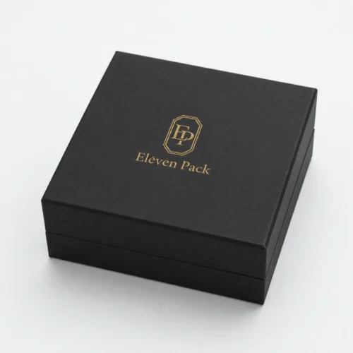 Closed black cardboard jewelry box with centered gold Eleven Pack logo
