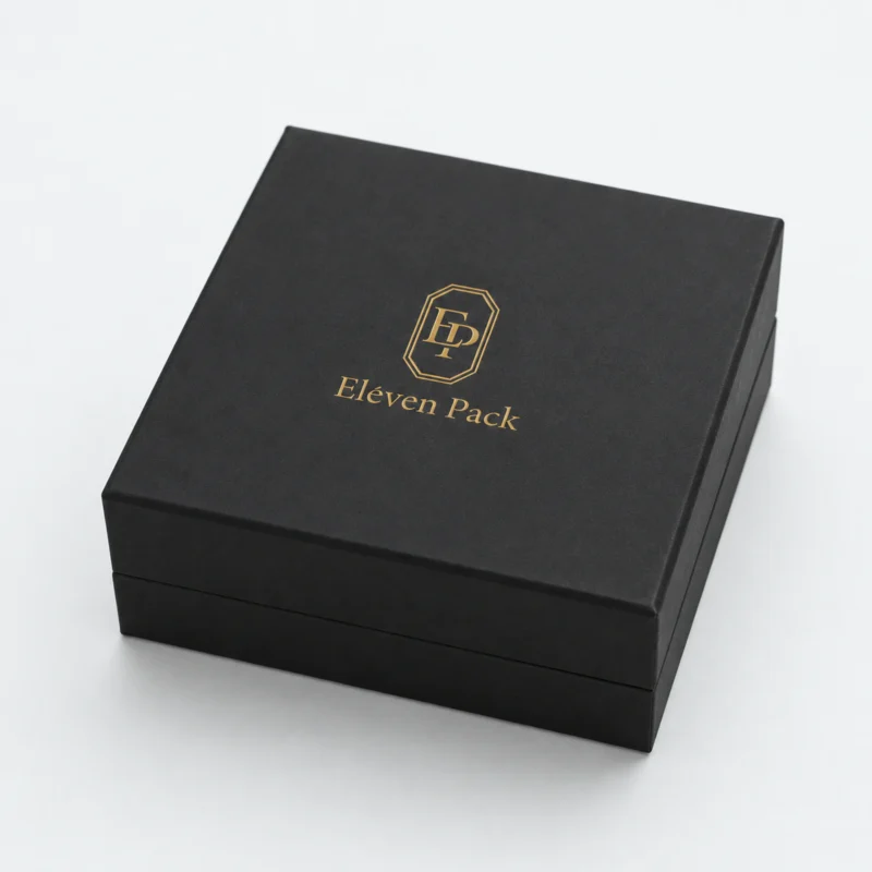 Closed black cardboard jewelry box with centered gold Eleven Pack logo