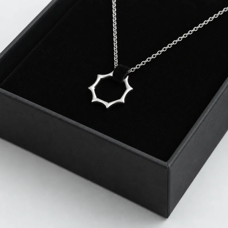 Close-up of black velvet necklace support and wrapped tray edge inside the box