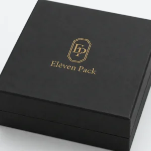 Close-up of gold foil logo, black paper grain and wrapped lid edge