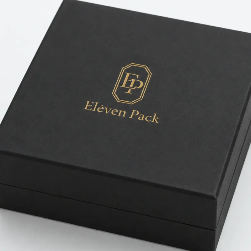 Close-up of gold foil logo, black paper grain and wrapped lid edge