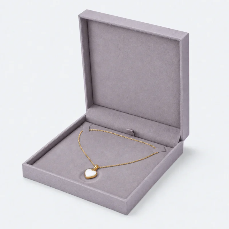 Open gray lilac linen necklace box with two chain tabs and centered heart pendant