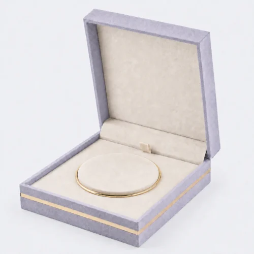 Open lavender fabric jewelry box with cream lining and round bangle cushion