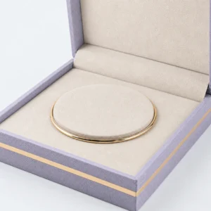 custom velvet fabric hinged jewelry box image 03 round bangle cushion JB-BM-02-P4 Close-up of cream textile cushion and slim gold bangle seated around its edge