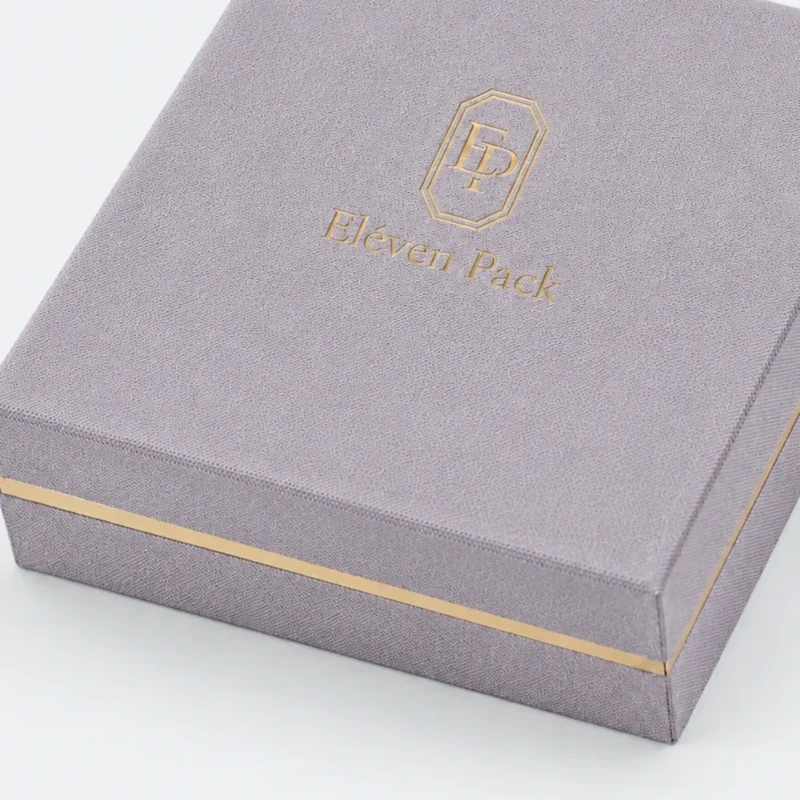custom velvet fabric hinged jewelry box image 04 gold band finish JB-BM-02-P4 Close-up of lavender fabric grain, gold band and wrapped lid edge