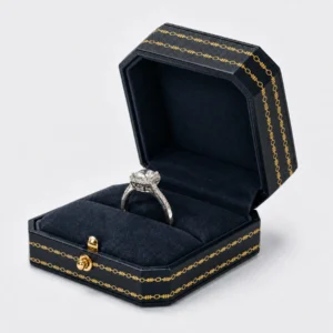Open dark blue leather ring box with navy velvet rolls, gold clasp and unified trim