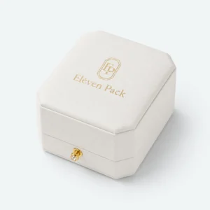Closed white leather ring box with centered gold logo and front clasp