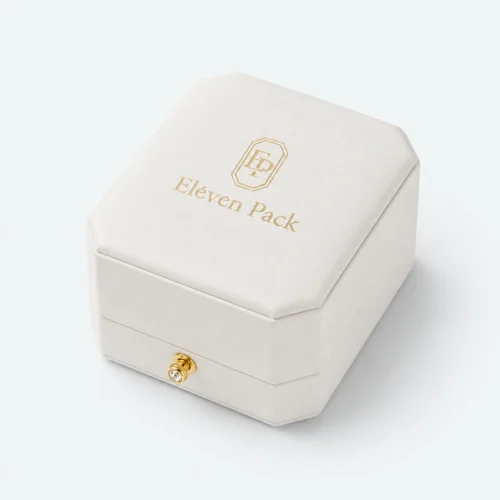 Closed white leather ring box with centered gold logo and front clasp