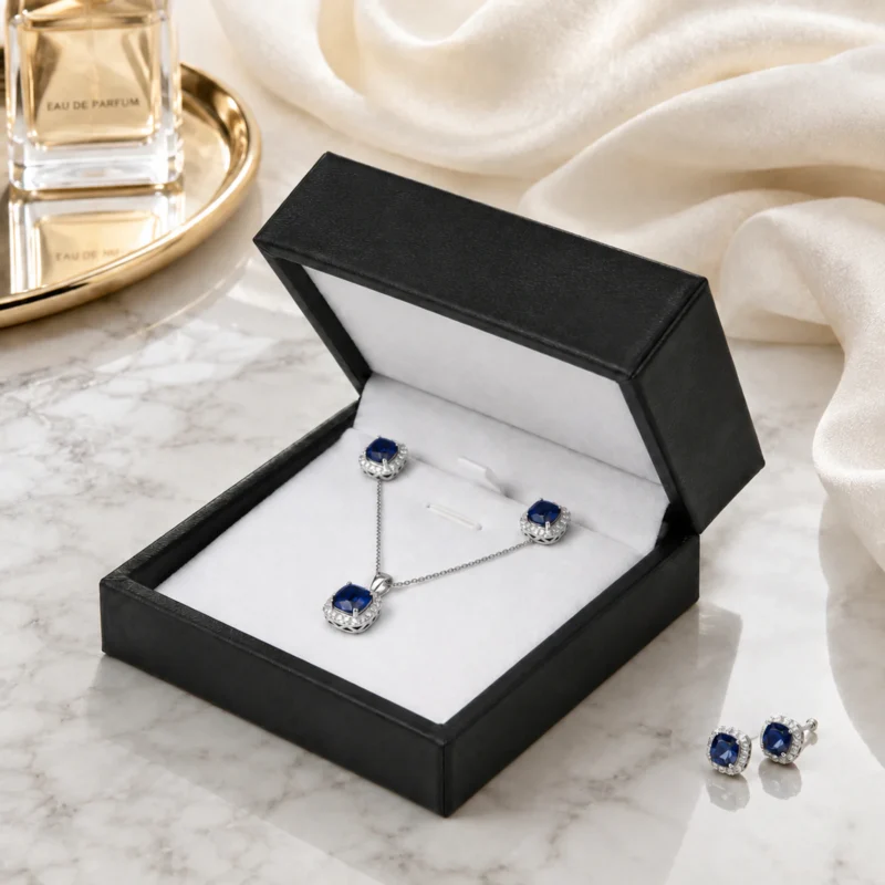 custom black pu leather necklace box image 05 usage scene JB-BM-05-P24 Open black PU leather necklace box in a premium marble and satin retail scene