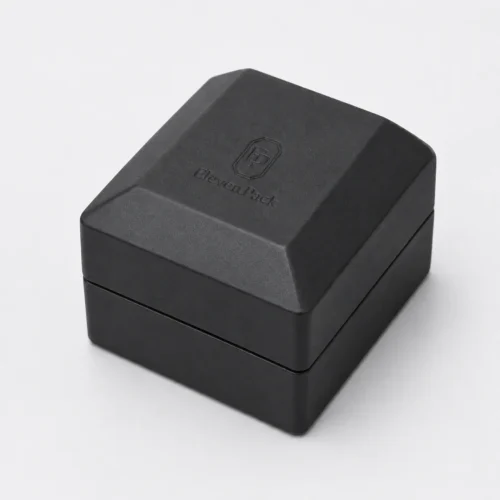 Closed black faceted PU leather ring box with subtle debossed logo