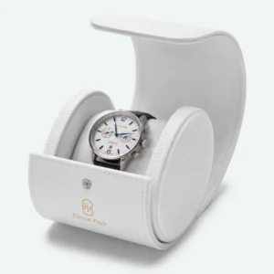 Open white leather watch box with padded cushion and snap-front closure